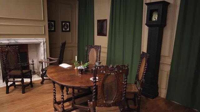 Interior Of A Living Room Of A 19th Century English House With A Table And Chairs In The Center