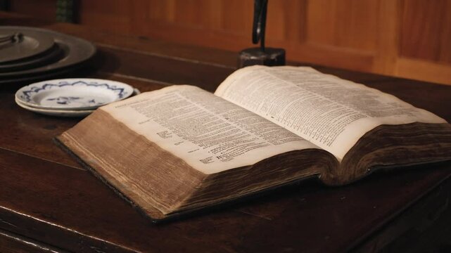 Opened Old Book Lying On A Wooden Vintage Table Close-Up