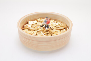 Miniature Figure With Gold Nuggets in Wooden Bowl Depicting Wealth
