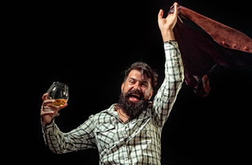 Whiskey glass held by bearded man. Guy drinking whiskey alone at bar. Whiskey pour in classic vintage glass. Whiskey tasting with retro style. Expensive whisky. Cognac or whisky. Alcoholic beverage.