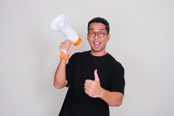 A man holding megaphone and give thumbs up with excited face expression