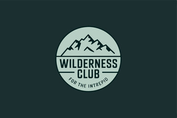 Wilderness club logo design featuring mountain peaks ideal for outdoor adventure or exploration branding