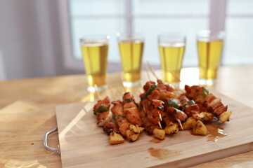 A joyful, multicultural group of friends and family gather outdoors at night, dancing, laughing, and enjoying music, wine, and warm conversation by the fire.