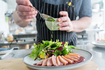 The chef serves roast duck. 