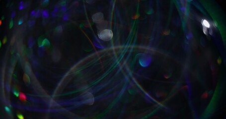 Lens flare. Blurred garland. Defocused blue green sparks multicolored radiance bokeh light abstract background.