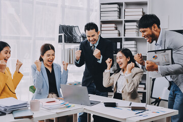 Group of Young Asian business team creative businesspeople coworker in office Happy to be successful partnership teamwork celebrating achievement and success concept.