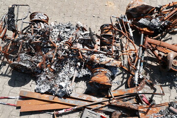 A pile of rusted metal and burnt car parts