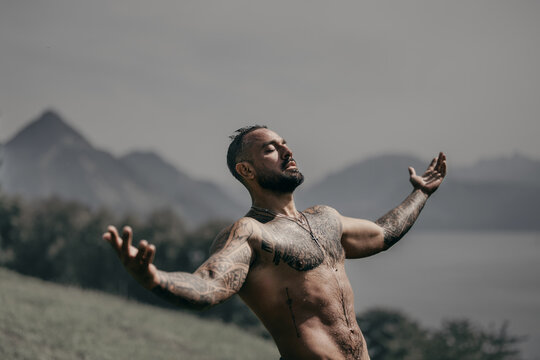 Powerful man on nature. Sexy shirtless man splashing under waterfall. Fit and strong male body in nature. Sexy model enjoying summer. Man beauty. Muscular man with water drops torso.