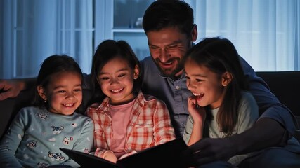 Father enjoys story time with daughters at home during a cozy evening, fostering happy memories and bonding moments
