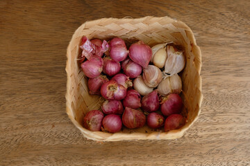 Obraz premium Traditional container made of weaved bamboo, to keep red onions and garlic