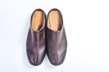 Brown leather slippers isolated on white background