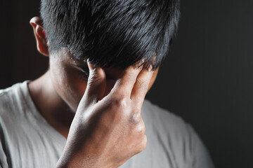 Fototapeta premium Frustrated young man expressing emotions in low light setting