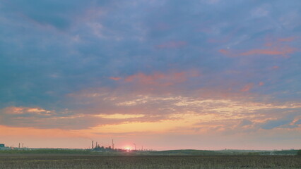 A Serene Sunset Gracing an Industrial Landscape, Creating a Tranquil Atmosphere and Beauty