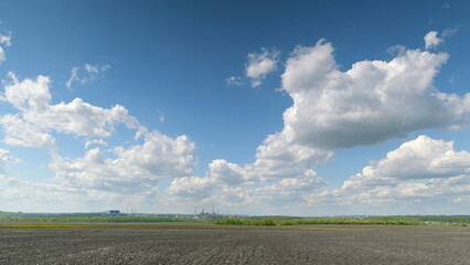 A beautiful scenic landscape adorned with a bright blue sky and a few fluffy clouds