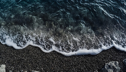 Fototapeta premium Overhead View of Dark Blue Ocean Waves Crashing on Black Pebble Beach creating a Dramatic and Natural Seascape with Dynamic Textures
