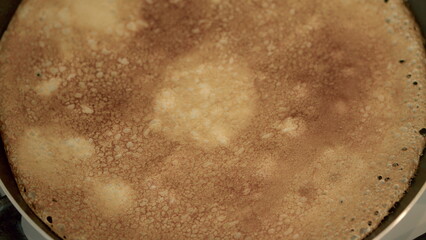Deliciously Golden Pancake Cooking Happily in a Pan for Breakfast and Brunch Enjoyment