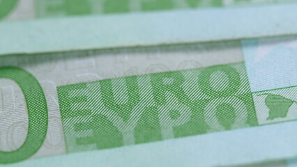 A CloseUp of Euro Banknotes that Display a Variety of Different Shades of Green Hues