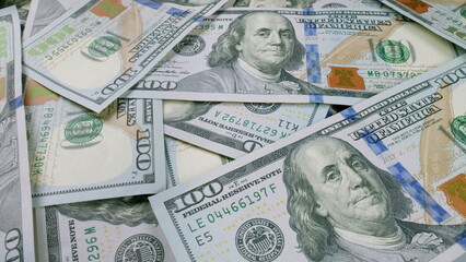 Stacks of U.S. Dollar Bills Neatly Laying on a Flat Surface in Organized Arrangement