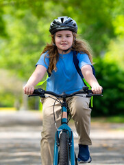 Child bike ride. Child biking down summer road. Kid riding bicycle with smile. Child cycling. Kid ride on bike. Happy boy on bike. Child biking outdoors. Children biking. Little biker.