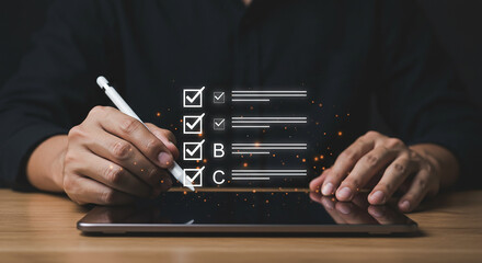Person using stylus on tablet to complete checklist with options a b and c on a wooden surface real estate business ,technology ,selling ,purchasing ,agreement ,$