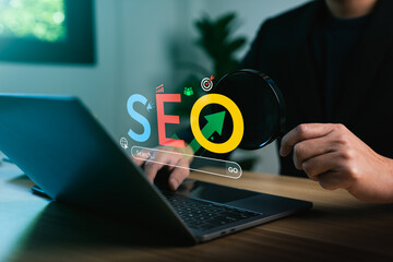 Digital marketing strategy concept showing SEO text with magnifying glass and laptop, illustrating search engine optimization, web traffic analytics, keyword ranking, and online visibility improvement