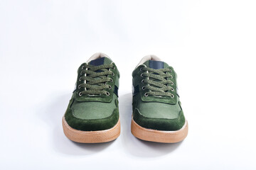 Casual style shoes made of green canvas fabric isolated on white background