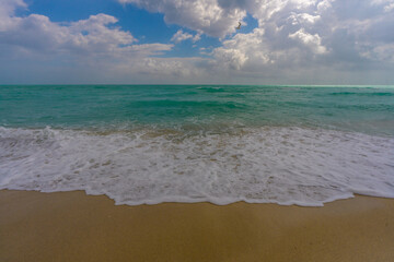 Relaxing seascape. Vacation shoreline. Luxury holiday resort. Light reflection on water. Coastal landscape. Turquoise lagoon. Golden sandy shore. Bright sunshine. Marine breeze. Tropical beach.