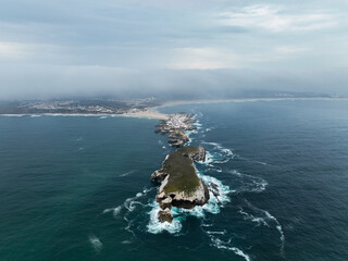 Aerial perspective of Baleal peninsula cliffs and connected coastal town