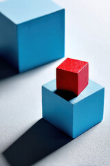 Fototapeta premium An incomplete blue square shape with one red cube standing apart
