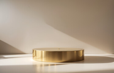 Golden cylinder podium on a white surface with a beige wall background.