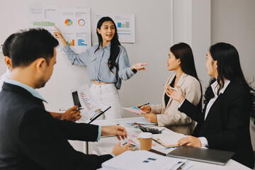 Team of financial advisory services. Asian advisor showing plan of investment to clients in the consultancy office..
