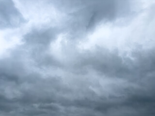 Overcast sky with dense, dark gray clouds indicating impending rain or storm, captured in natural daylight.