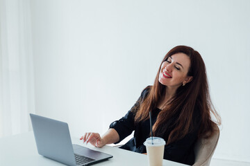 woman working with desk with laptop in white office online