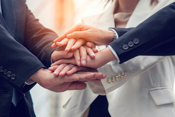 Obraz premium Diverse multiethnic Partners hands together teamwork group of multiracial people meeting join hands togetherness. Diversity people hands join empower partnership teams connection volunteer community