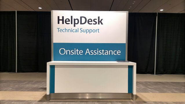 A modern Help Desk station offering technical support and onsite assistance, set against a backdrop of black curtains.
