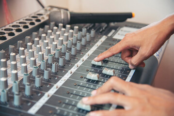 Production sound engineer woman hands adjusting volume equalizer voice, mixing console. DJ sound...