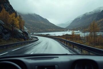 Driving along a winding road in the picturesque mountains of Norway during a rainy day, Driving a Car on a Road in Norway at dawn