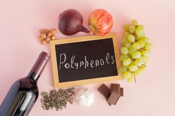 Products containing polyphenols in their composition. Grapes, onions, garlic, chocolate, green tea, close-up on a light background, flat lay