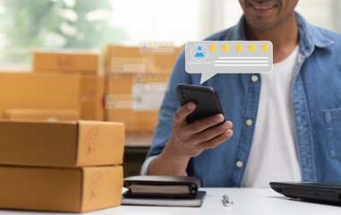 Customer review  on smartphone application with five star icon and comment feedback satisfaction service and man smiling in workplace,small business success concept