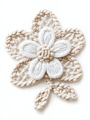 Fototapeta premium Delicate crocheted flower with a white center and beige petals, set against a white background