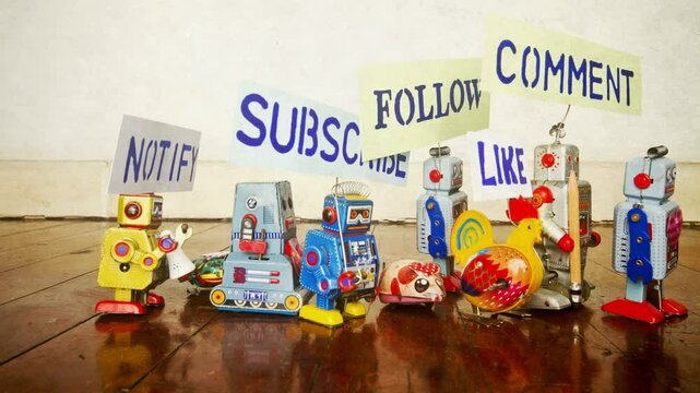 Robots with social media signs stop motion on a wooden floor