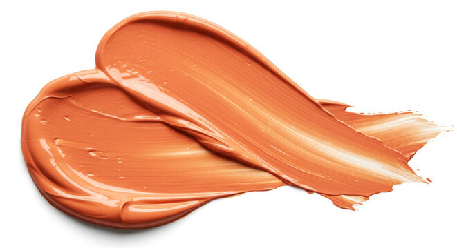 Peachy-toned makeup product smear against white backdrop. Cosmetics sample, studio shot.