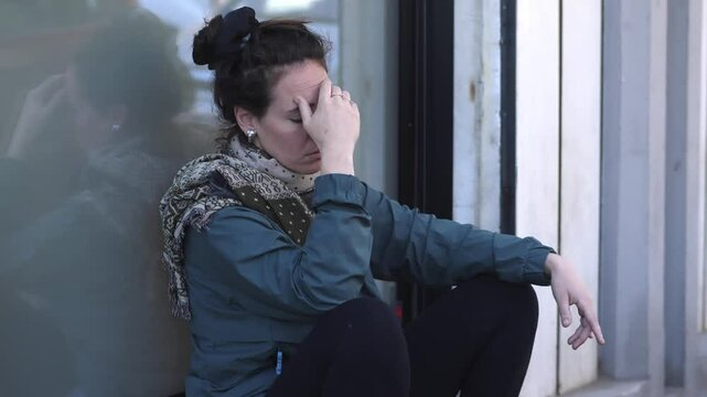 a brunette woman shows visible sadness in close-up after missing an important career opportunity, her face tense and full of regret