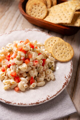 Macaroni salad with elbow pasta and canned tuna, served with saltine crackers. Easy and healthy recipe.
