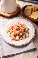 Macaroni salad with elbow pasta and canned tuna, served with saltine crackers. Easy and healthy recipe.