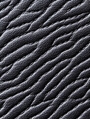 A close-up of black leather with a textured, wavy pattern