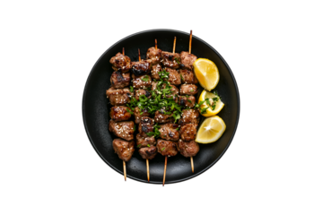 Delicious grilled beef skewers sesame seeds lemon garnish black plate
