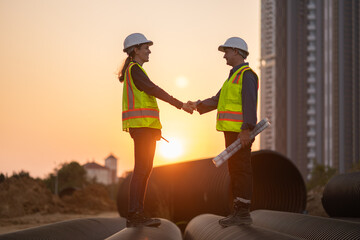 Construction surveyor or engineer working in pipe construction site for inspection detail of...