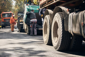 Heavy construction machines and truck outdoors for public street works.