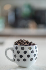 Fresh organic raw coffee beans in a mug